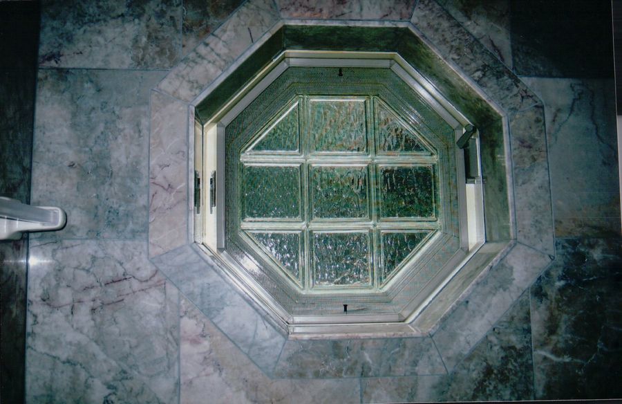 Green marble octagonal surround around a glass block window