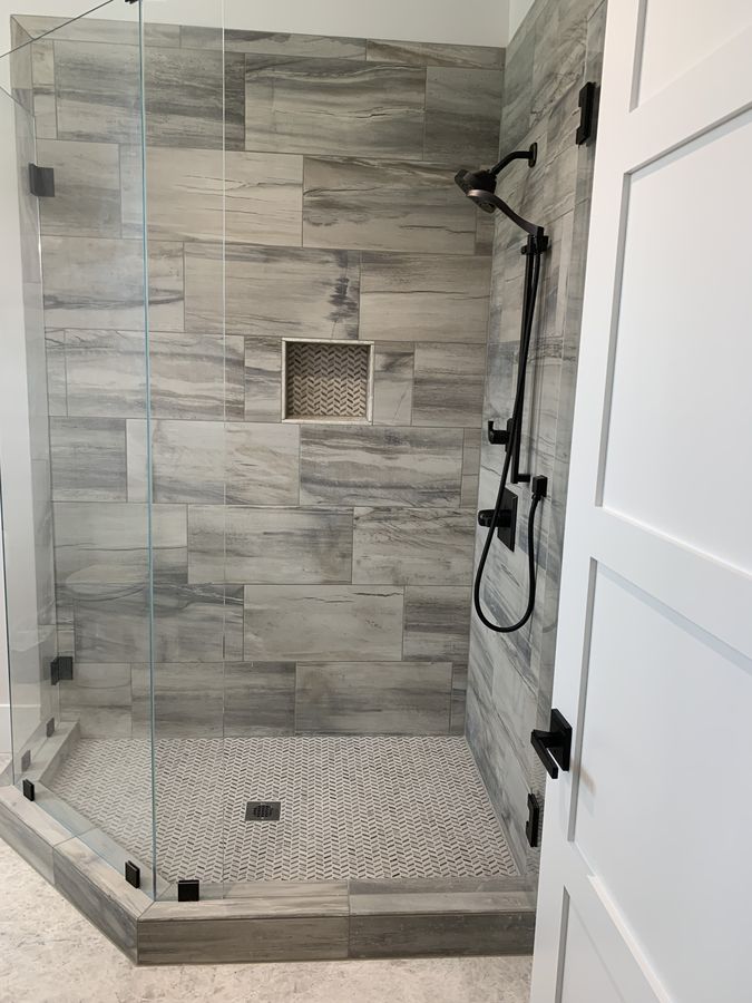 Shower niche lined with chevron mosaic